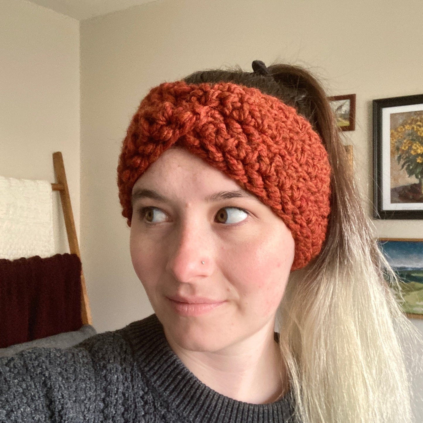 Leah wears Elizabeth Crochet Headband Twist with orange yarn.