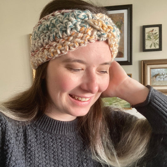 Leah wears Elizabeth Crochet Headband Twist with variegated rainbow yarn.